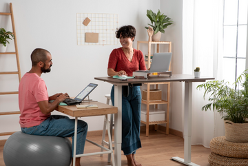 Standing desk vs. traditional desk side-by-side comparison in a home office setup.