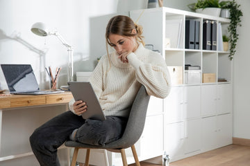 Woman working in a home office with custom timber furniture.